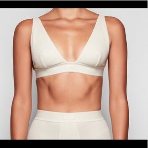 Skims “bone” bralette.